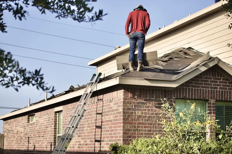 Professional roofer working on a residential roof in Lincoln Shire Square